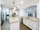 Gourmet kitchen with granite countertops, white cabinetry, stainless steel appliances, and island at 10319 Lavande Dr, Orlando, FL 32836