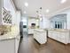 Stylish kitchen featuring granite counters, large island, stainless appliances, and wood flooring at 10319 Lavande Dr, Orlando, FL 32836
