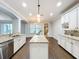 Spacious kitchen with white cabinets, granite countertops, and modern appliances at 10319 Lavande Dr, Orlando, FL 32836