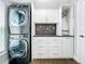 Convenient laundry room featuring stacked washer and dryer, cabinetry and counterspace at 10319 Lavande Dr, Orlando, FL 32836
