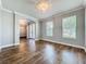 Bright, freshly painted living room with wood floors and large windows at 10319 Lavande Dr, Orlando, FL 32836