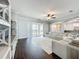 Spacious living room with dark floors, white leather sofas, and sliding glass doors at 10319 Lavande Dr, Orlando, FL 32836