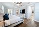 Bright main bedroom with wood floors, ceiling fan, and sliding glass doors to the patio at 10319 Lavande Dr, Orlando, FL 32836