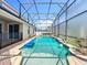 Inviting in-ground pool with a screen enclosure featuring a spa and an attractive outdoor space at 10319 Lavande Dr, Orlando, FL 32836