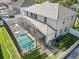Aerial view of a beautiful screened-in pool and patio area in backyard of two-story home at 10319 Lavande Dr, Orlando, FL 32836
