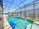 Relaxing in-ground pool featuring a spa and a screen enclosure, perfect for enjoying sunny days at 10319 Lavande Dr, Orlando, FL 32836