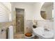 Updated bathroom featuring tan tile, a pedestal sink, and walk-in shower with glass door at 105 John Anderson Dr, Ormond Beach, FL 32176