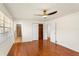 Spacious bedroom with hardwood floors, ceiling fan, and a closet with wood shelving at 105 John Anderson Dr, Ormond Beach, FL 32176