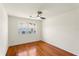 Bedroom with hardwood floors, ceiling fan and a window offering neighborhood views at 105 John Anderson Dr, Ormond Beach, FL 32176