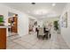 Bright dining area featuring tile floors, modern lighting, and open access to other living spaces at 105 John Anderson Dr, Ormond Beach, FL 32176