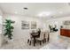 Open dining area with tile floors, stylish lighting, and seamless flow to adjacent living spaces at 105 John Anderson Dr, Ormond Beach, FL 32176