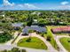 Expansive property featuring a well-maintained lawn, brick driveway, and a charming single-story home at 105 John Anderson Dr, Ormond Beach, FL 32176