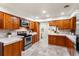 Well-equipped kitchen with modern appliances, wood cabinetry, granite countertops and tiled floor at 105 John Anderson Dr, Ormond Beach, FL 32176