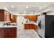Modern kitchen with stainless steel appliances, wood cabinets and granite countertops, and tile flooring at 105 John Anderson Dr, Ormond Beach, FL 32176