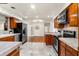 Spacious kitchen features wood cabinets, granite countertops, stainless steel appliances, and tile floors at 105 John Anderson Dr, Ormond Beach, FL 32176