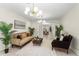 Bright living room with large windows, stylish furnishings, and open access to dining area with tiled floors at 105 John Anderson Dr, Ormond Beach, FL 32176
