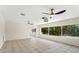 Bright, open living room featuring tiled floors, large windows and ceiling fans at 105 John Anderson Dr, Ormond Beach, FL 32176