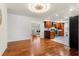 Open living area showcasing wood floors, modern lighting, and a view of an updated kitchen at 105 John Anderson Dr, Ormond Beach, FL 32176