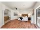 Main bedroom boasts wood floors, ceiling fan, and access to ensuite bathroom and patio at 105 John Anderson Dr, Ormond Beach, FL 32176