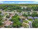 Overhead view of a charming neighborhood highlighting houses with pools and tree-covered yards in a suburban setting at 117 Burns Ave, Longwood, FL 32750