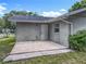 Covered back porch entrance with door adds outdoor access and shelter at 117 Burns Ave, Longwood, FL 32750