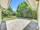 Backyard with a concrete patio and view of the fenced yard with mature trees at 117 Burns Ave, Longwood, FL 32750