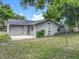 An exterior view featuring a well-kept lawn, access door, and green landscaping at 117 Burns Ave, Longwood, FL 32750