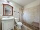 Bathroom with a single sink vanity and tiled walk-in shower featuring a bench at 117 Burns Ave, Longwood, FL 32750