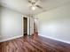 Bedroom with wood floors, neutral paint and an open closet at 117 Burns Ave, Longwood, FL 32750