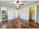 Bedroom featuring hardwood floors, a ceiling fan, and an open closet space at 117 Burns Ave, Longwood, FL 32750