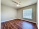 Bedroom with wood floors, neutral paint, ceiling fan and a bright window at 117 Burns Ave, Longwood, FL 32750