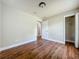 Bedroom with wood floors, neutral paint and an open closet at 117 Burns Ave, Longwood, FL 32750