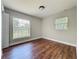 Bedroom with wood floors, two bright windows and neutral paint at 117 Burns Ave, Longwood, FL 32750