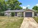 Attractive single-story home with a neat lawn and a convenient attached single car garage at 117 Burns Ave, Longwood, FL 32750