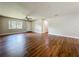 The living room features hardwood floors, a window, and access to other areas of the home at 117 Burns Ave, Longwood, FL 32750