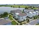 Aerial view showcasing modern townhomes, lakeside living, and community layout with green spaces at 12468 Koshiba Aly, Orlando, FL 32827