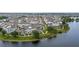 Waterfront community featuring contemporary townhomes with landscaping, near a picturesque lake setting at 12468 Koshiba Aly, Orlando, FL 32827