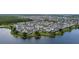 New development featuring tightly packed townhomes with serene lakefront views and community green spaces at 12468 Koshiba Aly, Orlando, FL 32827