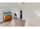 Bright bedroom boasts wood floors, modern media center, and is filled with natural light at 12468 Koshiba Aly, Orlando, FL 32827
