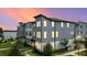 Beautiful townhouse showcasing modern architecture with picturesque sunset backdrop at 12468 Koshiba Aly, Orlando, FL 32827