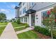 Charming townhome featuring a welcoming front yard and modern architectural details at 12468 Koshiba Aly, Orlando, FL 32827
