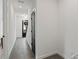 Clean hallway boasts tile flooring and a view of the home's front entrance at 12468 Koshiba Aly, Orlando, FL 32827