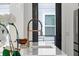Close-up of a modern kitchen faucet with a white quartz countertop at 12468 Koshiba Aly, Orlando, FL 32827
