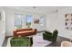 Bright living room featuring comfortable seating and serene water view from large windows at 12468 Koshiba Aly, Orlando, FL 32827