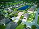 Aerial view showing neighborhood homes surrounding a large pond with lush trees and green lawns at 12832 Sawgrass Pine Cir, Orlando, FL 32824