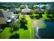 Aerial view of a house with a large backyard overlooking a scenic pond and lush landscaping at 12832 Sawgrass Pine Cir, Orlando, FL 32824