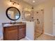 Bathroom with granite countertops, a glass shower, and a vanity with a modern mirror at 12832 Sawgrass Pine Cir, Orlando, FL 32824
