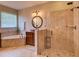Beautiful bathroom featuring a large glass shower, granite counters, and tile floors at 12832 Sawgrass Pine Cir, Orlando, FL 32824