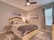 Cozy bedroom featuring wood flooring, a ceiling fan, and a comfortable bed at 12832 Sawgrass Pine Cir, Orlando, FL 32824