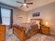 Bedroom with wooden furniture, a ceiling fan, and natural light from a window at 12832 Sawgrass Pine Cir, Orlando, FL 32824